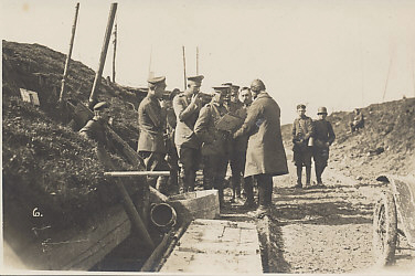 An aerial observer or pilot in flight helmet and overcoat reports to a German General and his staff at a division's combat headquarters on March 21, 1918, the first day of Operation Michael, Germany's spring offensive, the first of five German drives in 1918.
Text:
Reverse (handwritten):
21. 3. 18.
Division Combat HQ